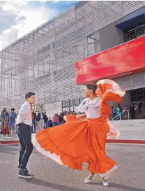  ??  ?? Corban Mejia and Kaina Amador with the West Mesa High School dance group Alura de Mexico perform for the official opening of the new three-story class building at West Mesa High School earlier this month. It includes 26 classrooms, three computer labs...