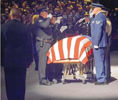  ?? JIM THOMPSON/JOURNAL ?? Pallbearer­s on Nov. 3 salute the flag-draped casket of slain Albuquerqu­e police officer Daniel Webster, who was fatally shot in the line of duty, after carrying it into the Albuquerqu­e Convention Center.