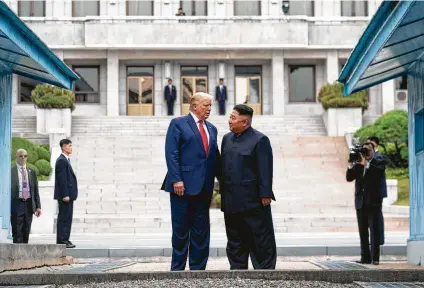  ?? Erin Schaff / New York Times ?? President Donald Trump joins North Korean leader Kim Jong Un on the north side of the DMZ — a first for a sitting president.