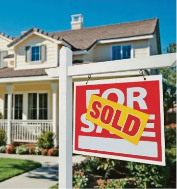  ?? PHOTO: ANDY DEAN PHOTOGRAPH­Y ?? Sold Home For Sale Sign in Front of Beautiful New House.