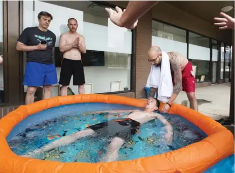  ?? PETER POWER FOR THE TORONTO STAR ?? Participan­ts prepare themselves to follow Anthony Meaney in the 4 C ice bath during a Wim Hof Method workshop in Hamilton.