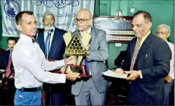  ??  ?? Champion S.H.M. Aslam of MSC receiving the M.J.M. Lafir Pot Black Snooker Trophy from chief guest Professor Ranjith Bandara.- Pictures by Samantha Perera.