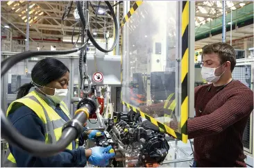  ??  ?? GROWTH ENGINE: Ford’s Dagenham plant is running again, with masks and shields for workers