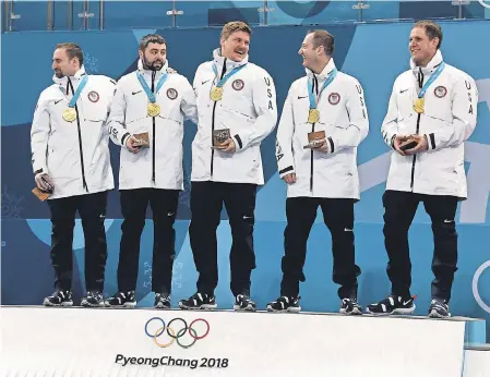  ?? JAMES LANG/USA TODAY SPORTS ?? Team USA, including from left, Joe Polo, John Landsteine­r, Matt Hamilton, Tyler George and John Shuster, celebrate winning the Americans’ first gold medal in curling in Winter Olympic history.