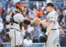  ?? Alex Gallardo / Associated Press ?? Mark Melancon is greeted by then-healthy catcher Buster Posey last Sunday after Melancon’s first save as a Giant.