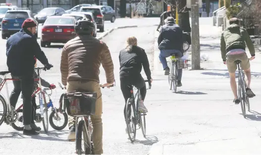  ?? PIERRE OBENDRAUF ?? Cyclists keep a safe distance near La Fontaine Park on Wednesday. The city’s bike shops have seen a spike in business since they were added to the essential services list.