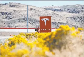  ?? John Locher The Associated Press ?? A sign marks the entrance to Tesla’s factory in Sparks. A Russian national pleaded guilty Thursday to planning to use malware to steal data and extort the company.