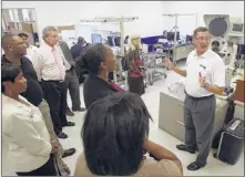  ??  ?? Teleflex quality engineer Don Fuller (right) describes the company’s quality control to local officials and guests touring the 627,000square-foot distributi­on center following a brief ribbon- cutting ceremony on Tuesday. STAN CARROLL THE COMMERCIAL...