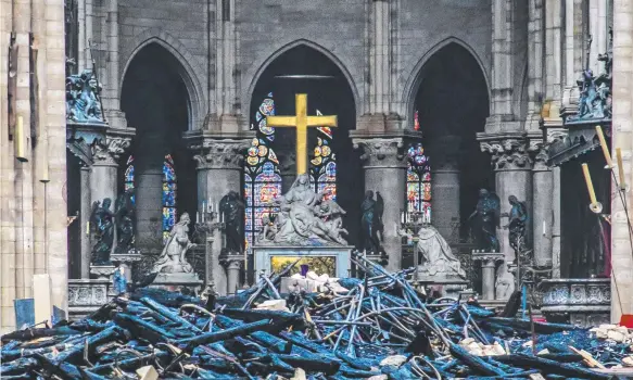  ?? Picture: AP ?? Debris is seen inside Notre Dame Cathedral in Paris, after firefighte­rs battled for 12 hours to extinguish an inferno engulfing the building,