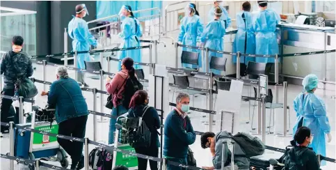  ?? Photo: Sam Tsang ?? Foreign passengers arrive in Hong Kong yesterday after the government eased restrictio­ns that had cut the city off from most of the world for more than two years.