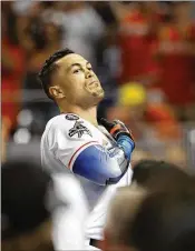  ?? JOE SKIPPER / GETTY IMAGES ?? Giancarlo Stanton acknowledg­es fans after his last atbat of the season. His future with the Marlins is unclear with the ownership change.