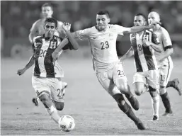  ?? Associated Press ?? Honduras' Jorge Claros, left, fights for the ball with Australia's Tomas Rogic during the first leg of a soccer World Cup qualifier play-off Sunday at the Olympic Stadium in San Pedro Sula, Honduras.