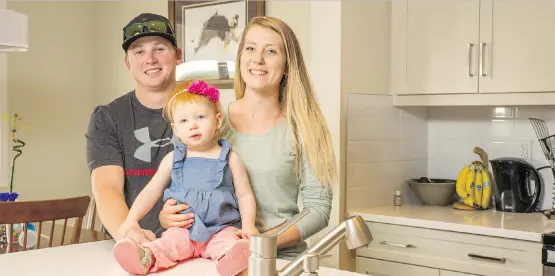  ?? DON MOLYNEAUX ?? Cody and Jocelyn Edwards, with their daughter Emery, bought a new home in the High River community of Montrose by Dream Developmen­t, rather than a fixer-upper.