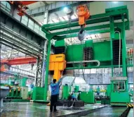  ?? PROVIDED TO CHINA DAILY ?? A giant crane lifts a compressor housing for processing at Shenyang Blower Works Group.