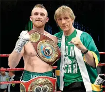  ??  ?? PACKING A PUNCH: Dennis Hogan with his trainer Glenn Rushton after a bout in Australia last year