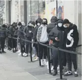  ??  ?? 0 Shoppers queue outside a Nike store