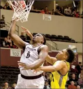  ?? Arkansas Democrat-Gazette/MELISSA SUE GERRITS ?? UALR forward Roger Woods (0) scored 13 points in the team’s 84-57 victory over Northern Arizona on Sunday. Woods and the Trojans will try to extend their winning streak to 11 games tonight at Texas Tech.