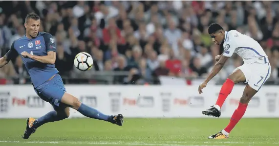  ??  ?? Marcus Rashford fires home England’s winning goal against Slovakia last night.