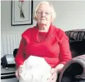  ??  ?? Pictured is Veronica Walkden holding her brother’s ashes.