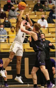  ?? (Special to NWA Democrat-Gazette/ David Beach) ?? Jaylen Lee (left) of Bentonvill­e takes a shot against Will Yoakley of Fayettevil­le on Friday at Tiger Arena in Bentonvill­e. Lee had a game-high 28 points as the Tigers won 79-55 in a Class 6A-West matchup.