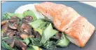  ?? A LITTLE YUMMINESS ?? A quick weeknight rice bowl features roast salmon fillets with mushrooms and bok choy.