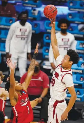  ?? Associated Press ?? Taking aim: Arkansas forward Jaylin Williams (10) shoots over Texas Tech guard Terrence Shannon Jr. in the second half of a second-round game in the NCAA men's college basketball tournament Sunday at Hinkle Fieldhouse in Indianapol­is.