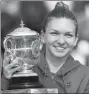  ?? REUTERS ?? Simona Halep clutches the trophy after winning the French Open on Saturday.