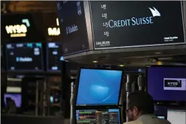  ?? SETH WENIG — THE ASSOCIATED PRESS ?? A sign displays the name of Credit Suisse on the floor at the New York Stock Exchange in New York on Wednesday.