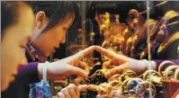  ?? PROVIDED TO CHINA DAILY ?? Consumers check gold accessorie­s at a jewelry store in Guangzhou, Guangdong province.