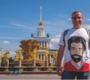  ??  ?? A fan wears a Mo Salah T-shirt by the Friendship of Nations fountain. Mohamed Salah plays for Egypt