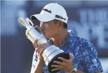  ?? Peter Morrison / Associated Press ?? Cal alumnus Collin Morikawa kisses the Claret Jug on the 18th green after winning the British Open at Royal St. George’s.