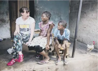  ??  ?? Pauline Cafferkey with orphans of Ebola who are being helped by the charity in Sierra Leone