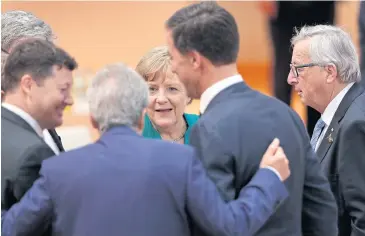  ?? AP ?? From right, European Commission President Jean-Claude Juncker, Mark Rutte, Prime Minister of the Netherland­s, German Chancellor Angela Merkel and Italian Prime Minister Paolo Gentiloni talk prior to a working session at the G20 summit on Saturday.