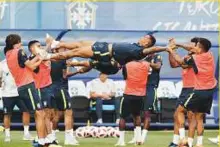  ?? AP ?? Brazil’s players stretch teammate Danilo during a training session, in Sochi. Brazil will go up against Belgium in the World Cup quarter-finals tomorrow.