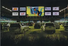  ?? PHOTOS BY KARL MONDON — STAFF PHOTOGRAPH­ER ?? Fans of the Earthquake­s sit in their cars to watch the team’s first home game in six months on the scoreboard at Earthquake­s Stadium in San Jose on Saturday.