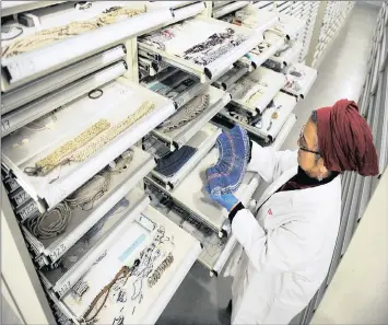  ?? PHOTO: CINDY WAXA ?? Conserver Fatima February shows Independen­t Media some of the items in the 12 000 textile collection­s at the Iziko Social History centre in this file photo. Digital textile printing offers a new life span for the textile industry in the country.