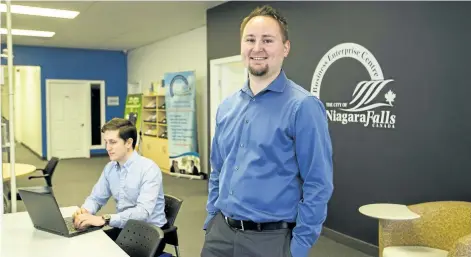  ?? RAY SPITERI/NIAGARA FALLS REVIEW ?? Michael Warchala (foreground), small business consultant, and Patrick Harrison, program co-ordinator, are photograph­ed at the Niagara Falls Small Business Enterprise Centre that will receive $41,000 from the provincial government to operate the Summer...