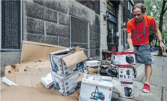  ?? DAVE SIDAWAY ?? Garbage on Tupper St. Resident Gregory Parent points out several boxes for the same household items, suggesting someone is renting out multiple short-term accommodat­ions in the apartment building.