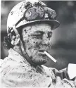  ??  ?? Outrider Randy Fisher has a smoke while wearing a lot of the mud from a sloppy track during the chuckwagon races on July 13, 1976.