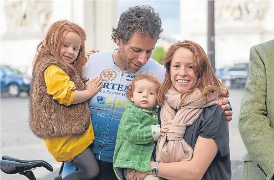  ??  ?? Mark Beaumont with his family after arriving in Paris to complete his marathon cycle ride.