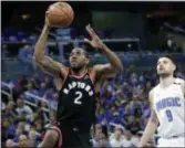  ?? THE ASSOCIATED PRESS FILE ?? Toronto’s Kawhi Leonard, left, takes a shot after getting past Orlando’s Nik Vucevic during Game 4 Sunday of a first-round series the Raptors easily won.