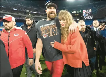  ?? JULIO CORTEZ/AP ?? Chiefs tight end Travis Kelce and Taylor Swift walk together after Kansas City’s AFC championsh­ip game win over the Ravens on Sunday in Baltimore.