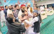  ?? AFP ?? Pakistani security personnel and organisers of a gathering tackle one of the men who threw a shoe at Nawaz Sharif.