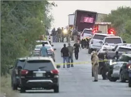  ?? Eric Gay Associated Press ?? AUTHORITIE­S investigat­e the scene where dozens of people were found dead in an airless tractor-trailer June 27 in San Antonio. Two men are in federal custody.