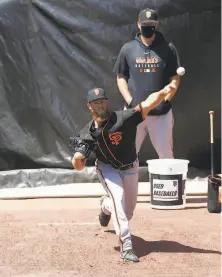  ?? Lea Suzuki / The Chronicle ?? Lefthander Conner Menez warms up in the bullpen at Oracle Park. Menez, who made three starts for the Giants last season, tossed two perfect innings Monday.