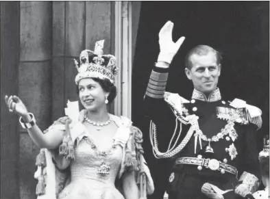  ?? PA Photos / TNS ?? Queen Elizabeth II wearing the Imperial State Crown and the Duke of Edinburgh in uniform of Admiral of the Fleet waving from the balcony to the onlooking crowds around the gates of Buckingham Palace after the Coronation on June 2, 1953.
