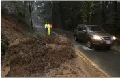  ?? KENT PORTER — THE PRESS DEMOCRAT VIA AP ?? A mudslide covers westbound Green Hill Road between Graton and Occidental on Thursday.