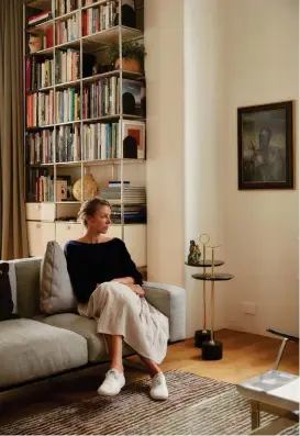  ??  ?? Left Kristina Pickford sits on the ‘Soft Dream’ sofa by Antonio Citterio for Flexiform. On the wall next to her is a painting by Heather Straka. The ‘Cigg’ side tables are by Jader Almeida for Sollos. The bookshelf is by USM Haller.