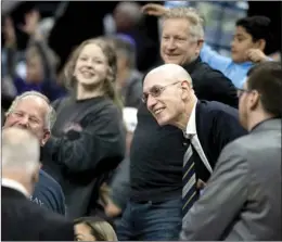  ?? AP photo ?? NBA Commission­er Adam Silver, center, takes photograph­s with fans during the second half of a game between Sacramento and Philadelph­ia in Sacramento, Calif., on March 25.