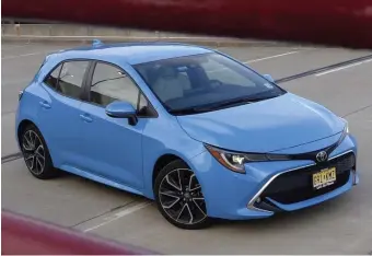  ?? CHRISTOPHE­R EVANS / HERALD STAFF ?? UTILITY PLAYER: The 2019 Toyota Corolla Hatchback is a capable carrier, with room inside for several sets of skis — though rear-seat passenger space is limited.